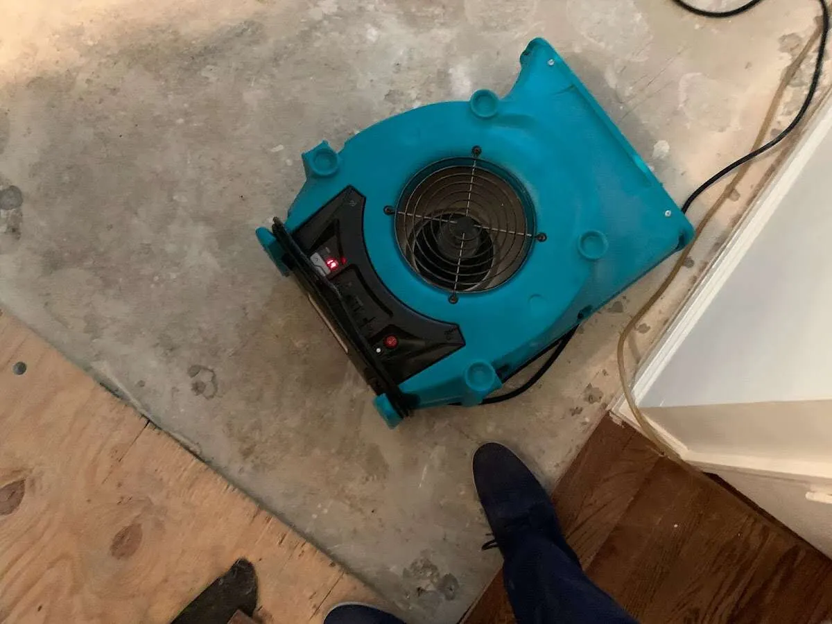 Air mover drying subfloor during Commercial Water Damage Restoration in McGregor
